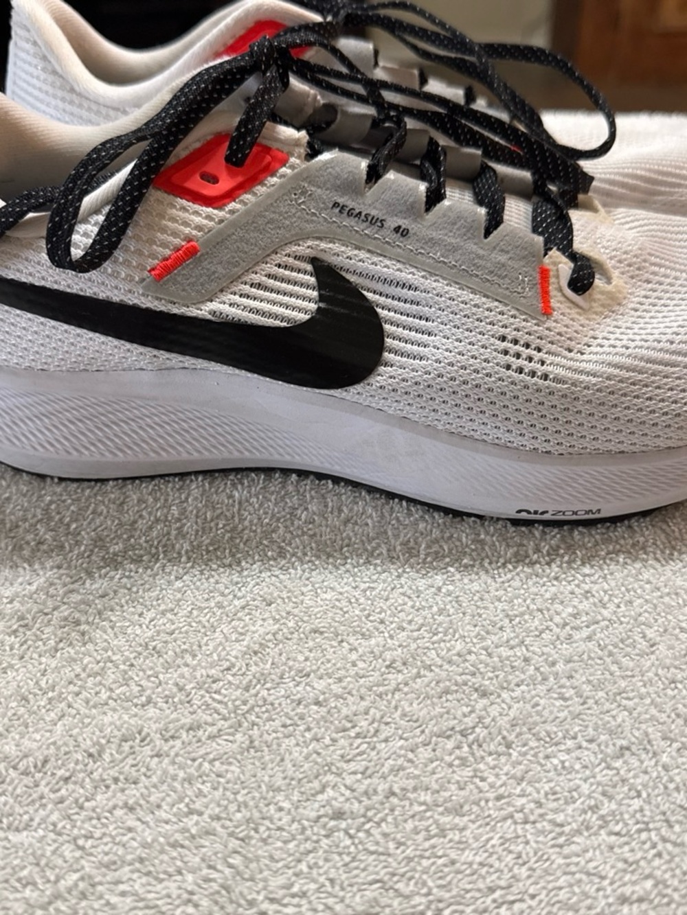 Nike White Running Shoe with Black Swoosh and Red Accents